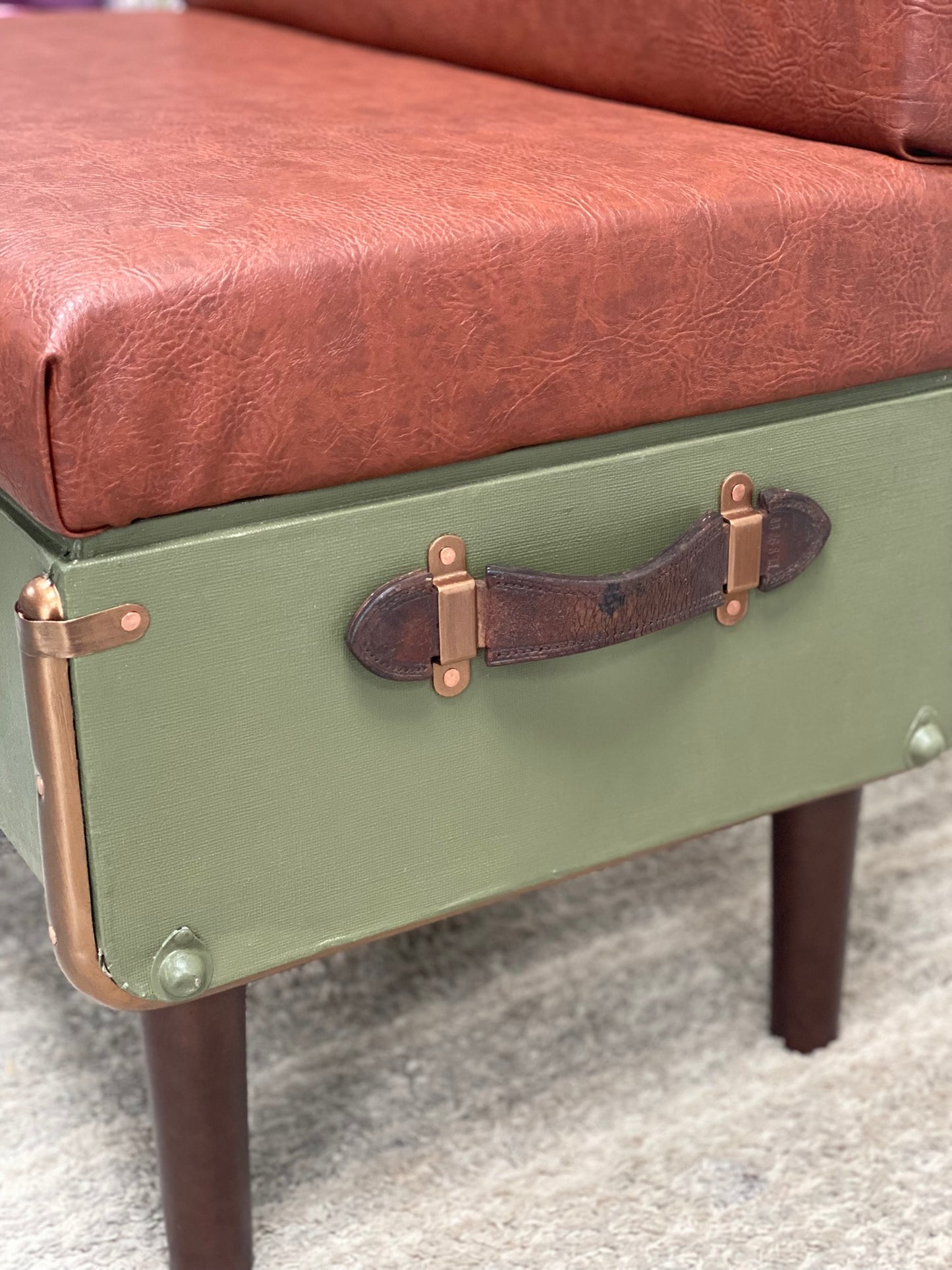 upcycled steamer trunk into a chair with brown leather seat