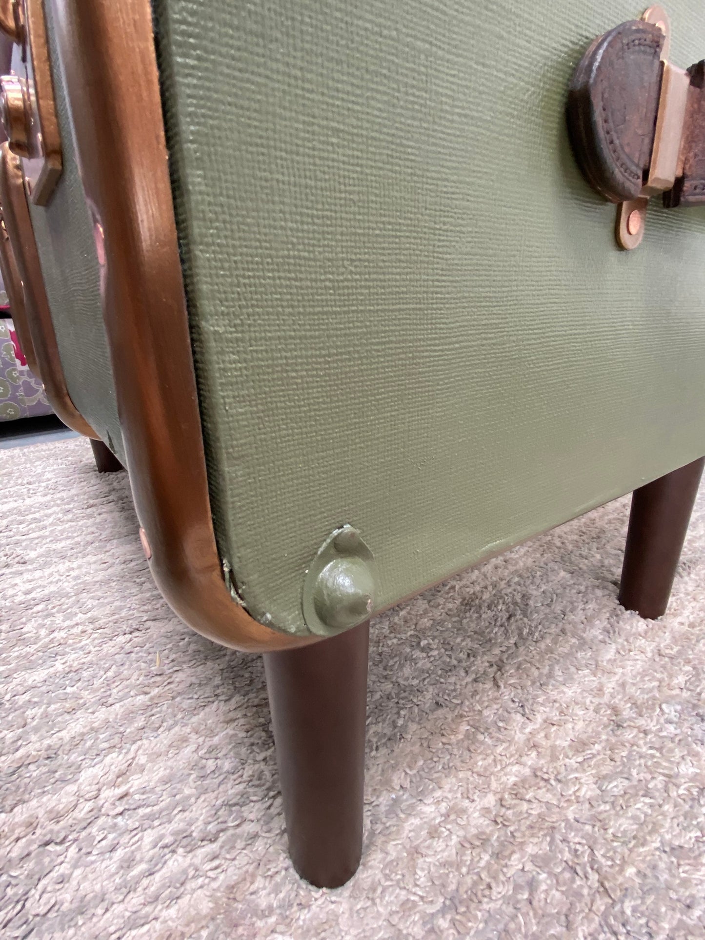 Close-up of case showing minor dented metal fitting and rip to fabric of the case